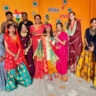 Students and teachers dressed in colorful traditional attire celebrating Krishna Janmashtami at San Marino Public Higher Secondary School, Gwalior.