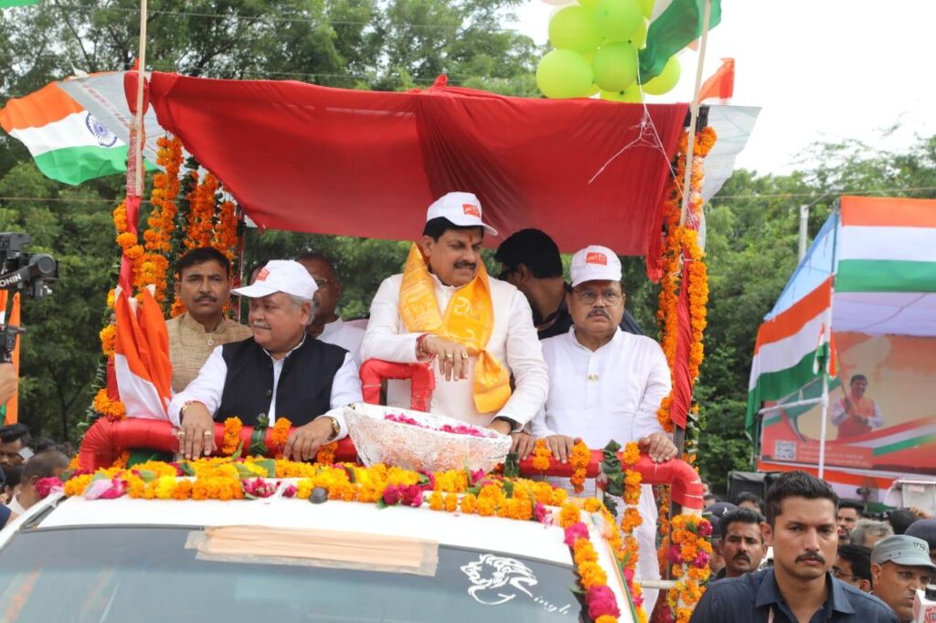 ग्वालियर में हर घर तिरंगा अभियान के तहत सजाए गए वाहन पर सवार मुख्यमंत्री डॉ. मोहन यादव और अन्य गणमान्य व्यक्ति, चारों ओर तिरंगे और फूलों से सजा माहौल।